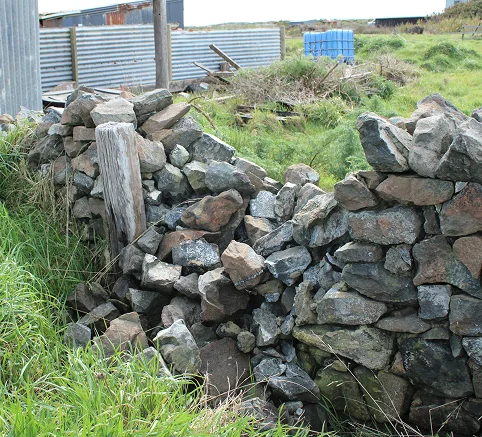 Dunite wall damaged Oki Street