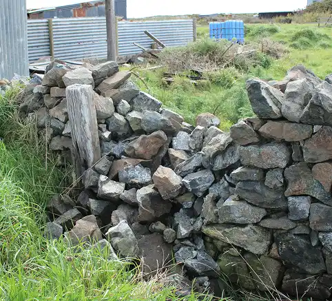 Dunite wall damaged Oki Street