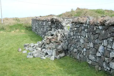 Dunite wall damaged Oki Street
