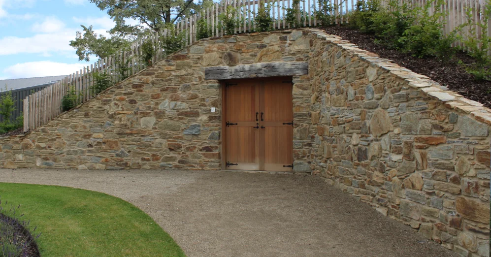 Otago schist stone wall with rustic door